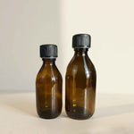 Bouteille en verre ambré avec bouchon sécurité enfants, idéale pour vos préparations maison.